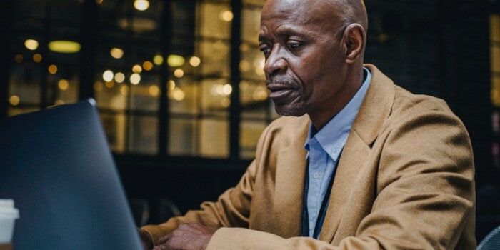Image of a man at his computer learning about prostate cancer markers.